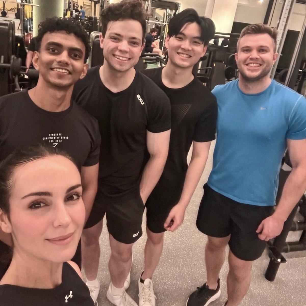 Draftable team members posing together at a gym