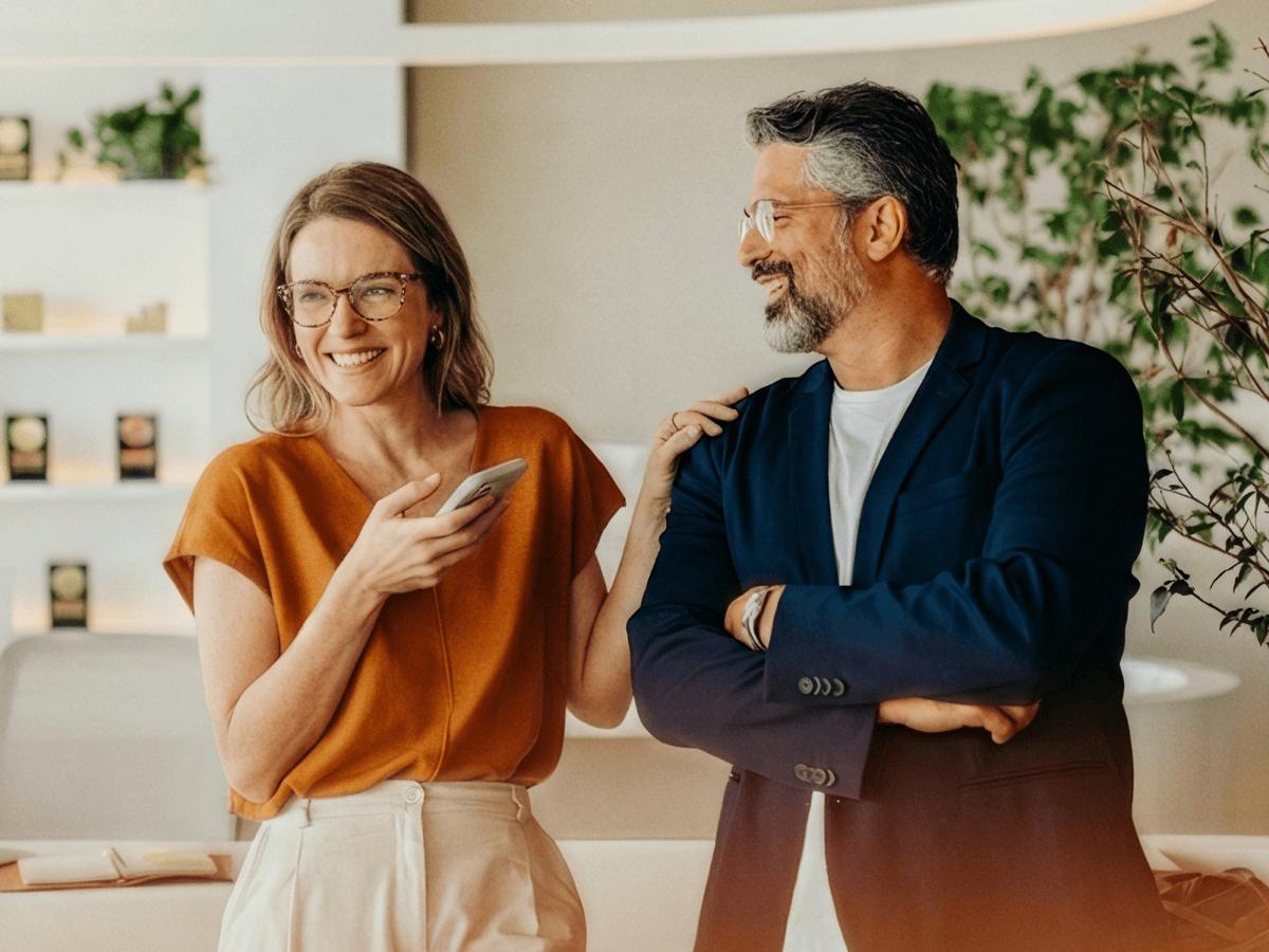 Two colleagues talking in a bright office