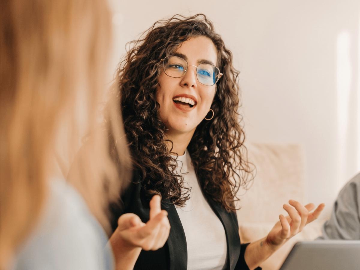 Woman laughing during a conversation