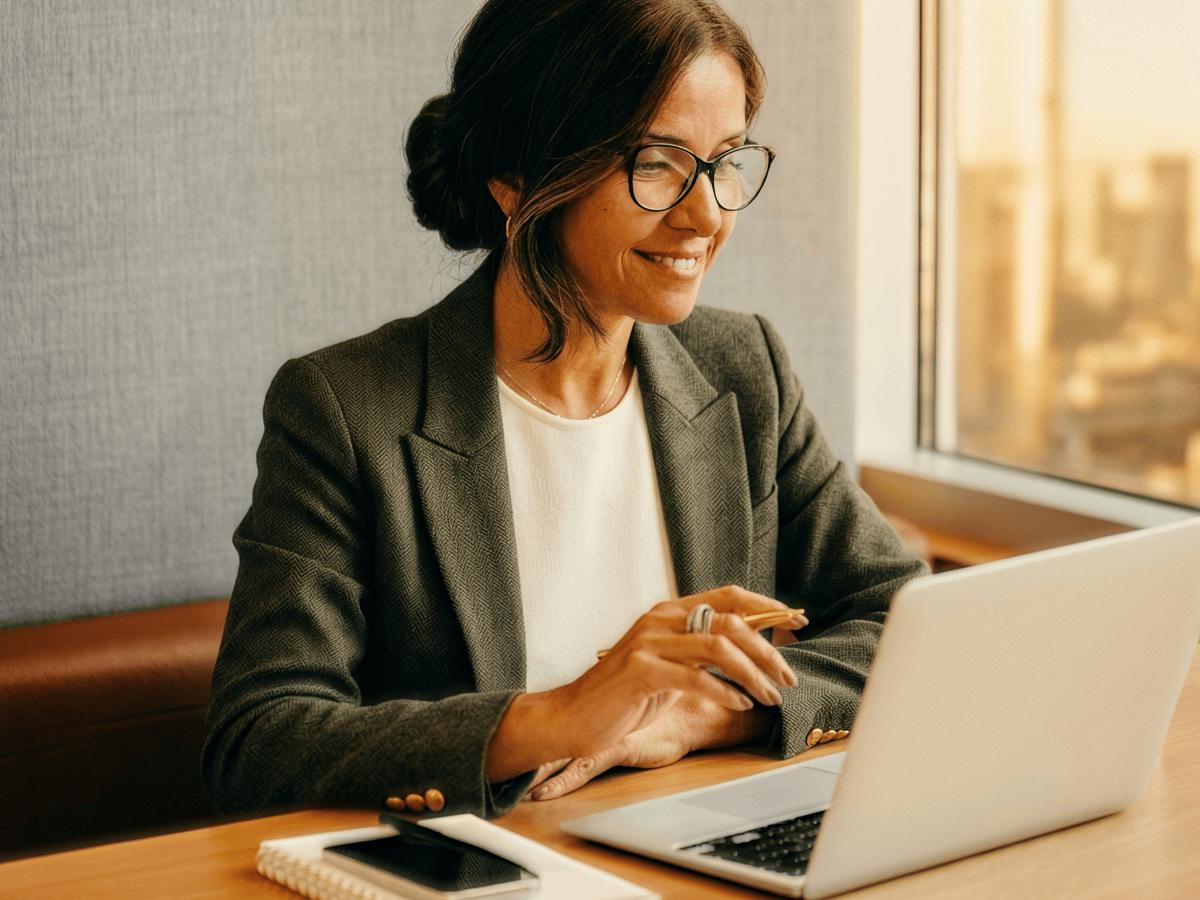 Professional woman working on a laptop at a desk