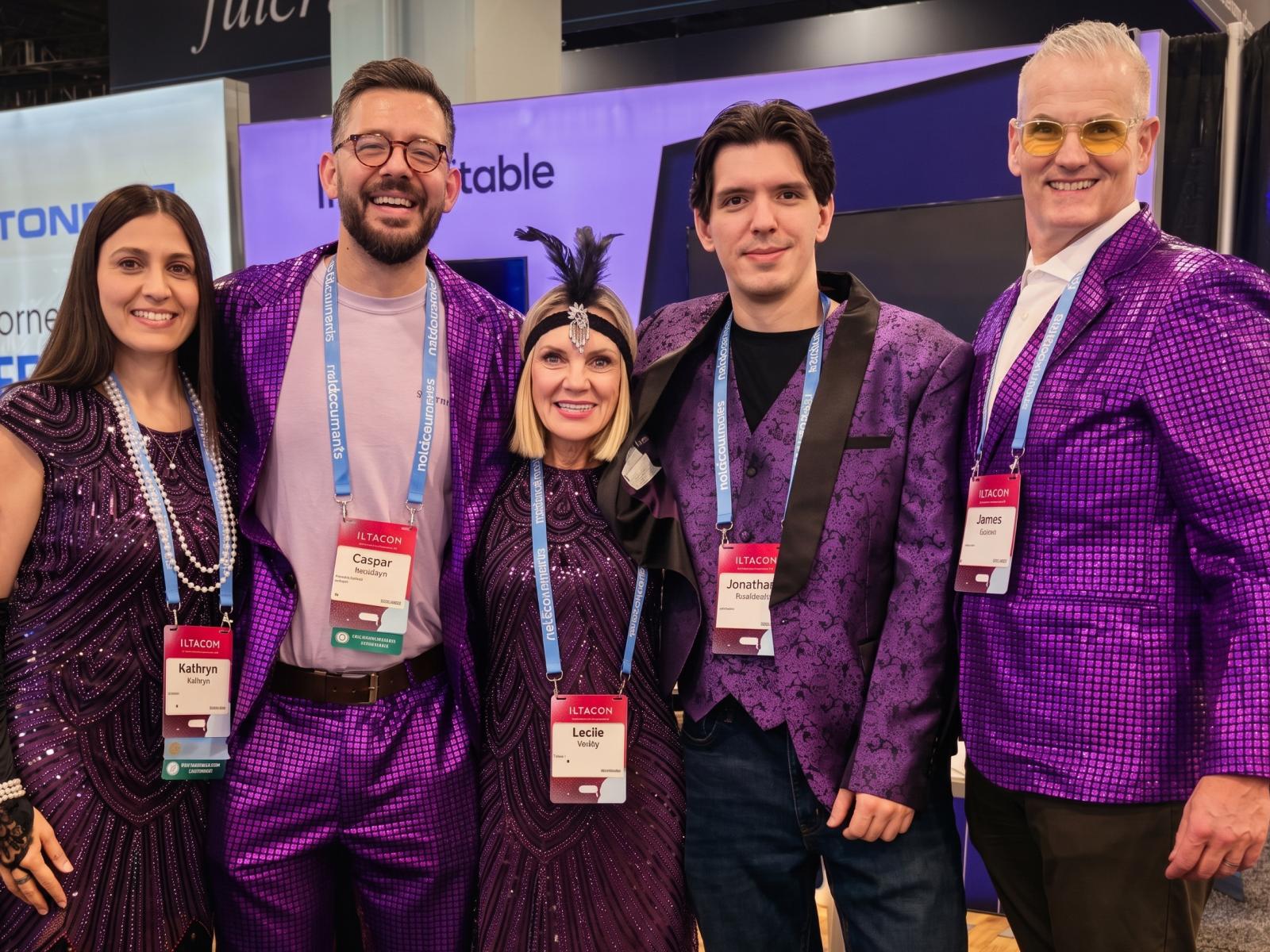 Draftable team at a conference event in purple outfits