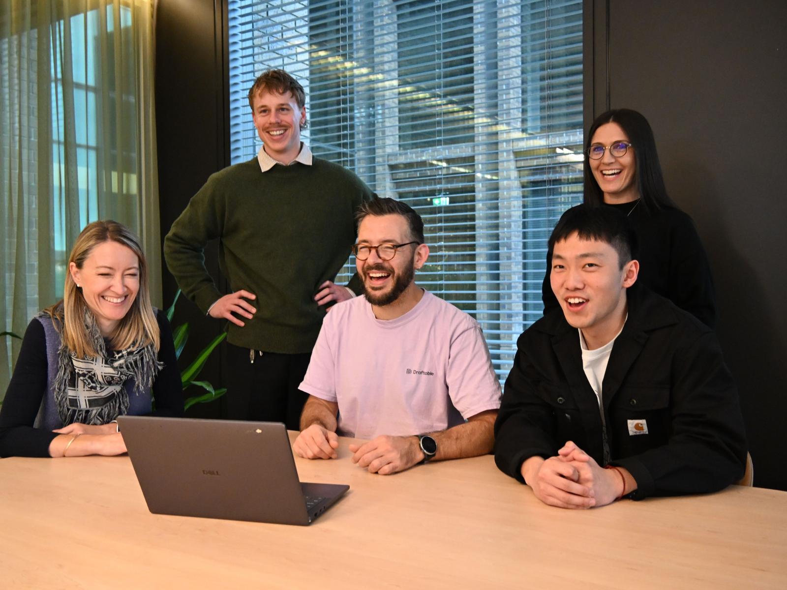 Draftable team members working together at a table