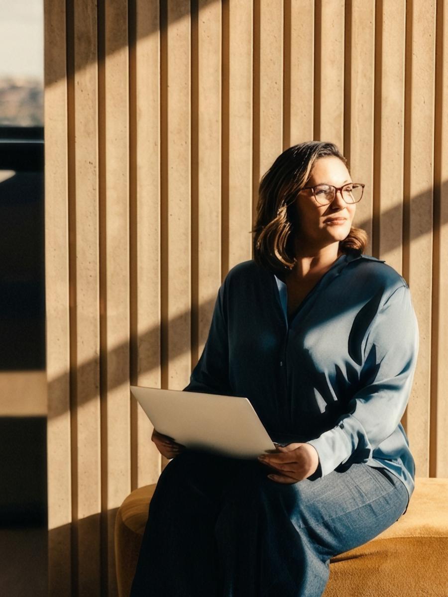 Woman working on a laptop in a modern office