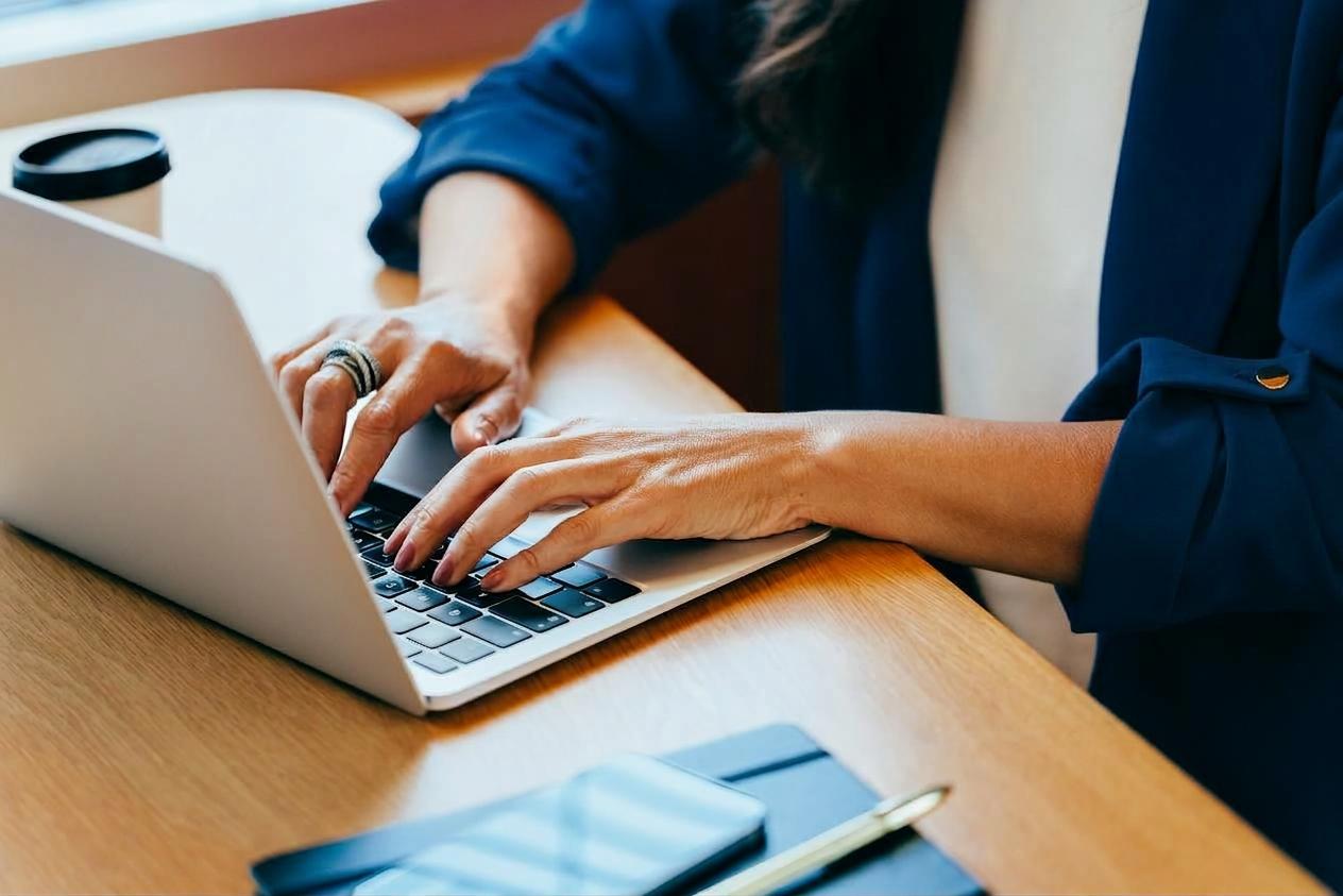 Person typing on a laptop at a desk